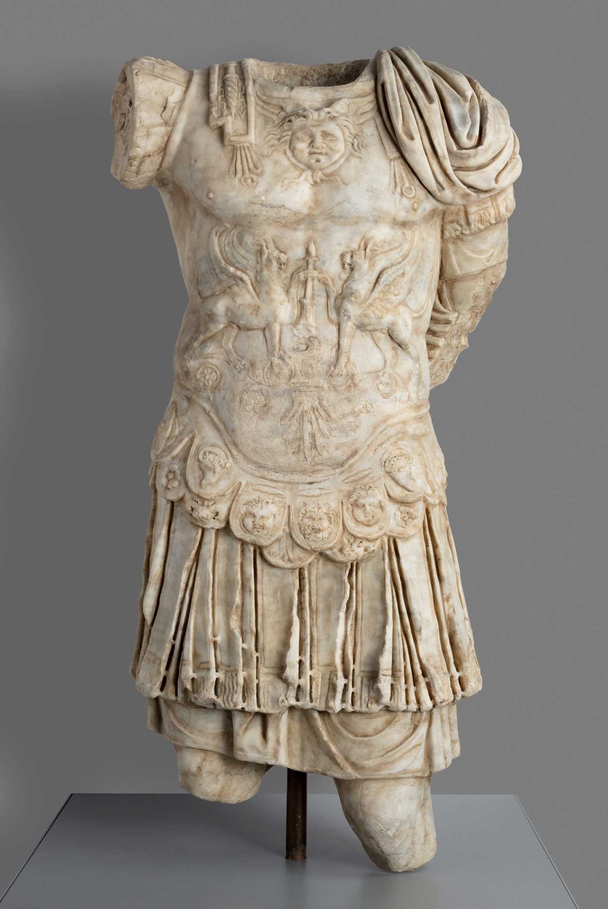 Marble sculpture of possible Roman emperor.  Figure is clad in miliary wear with torso covered in an armored cuirass decorated with motifs to offer protection from evil. 1-2nd C. Rome. Art Institute of Chicago.