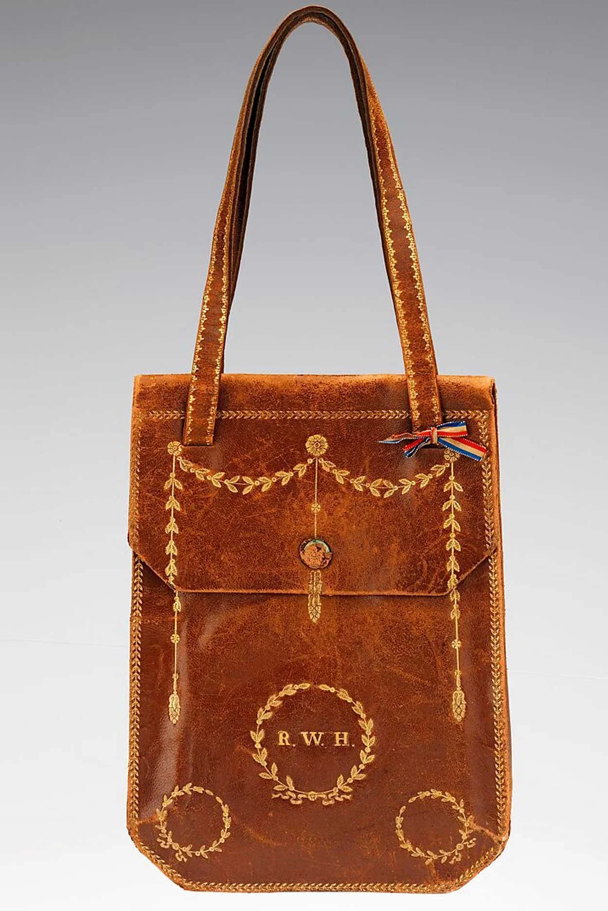 Leather bag made in a Roman workshop in the early 19th century but with neoclassical motifs of garland and wreath. Met Museum.