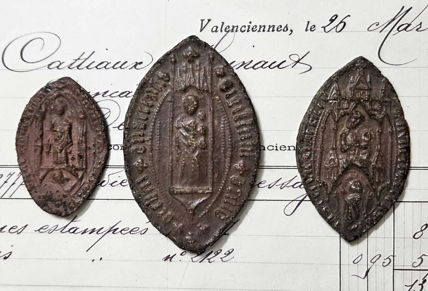 Pointed, ecclesiastical wax impressions.