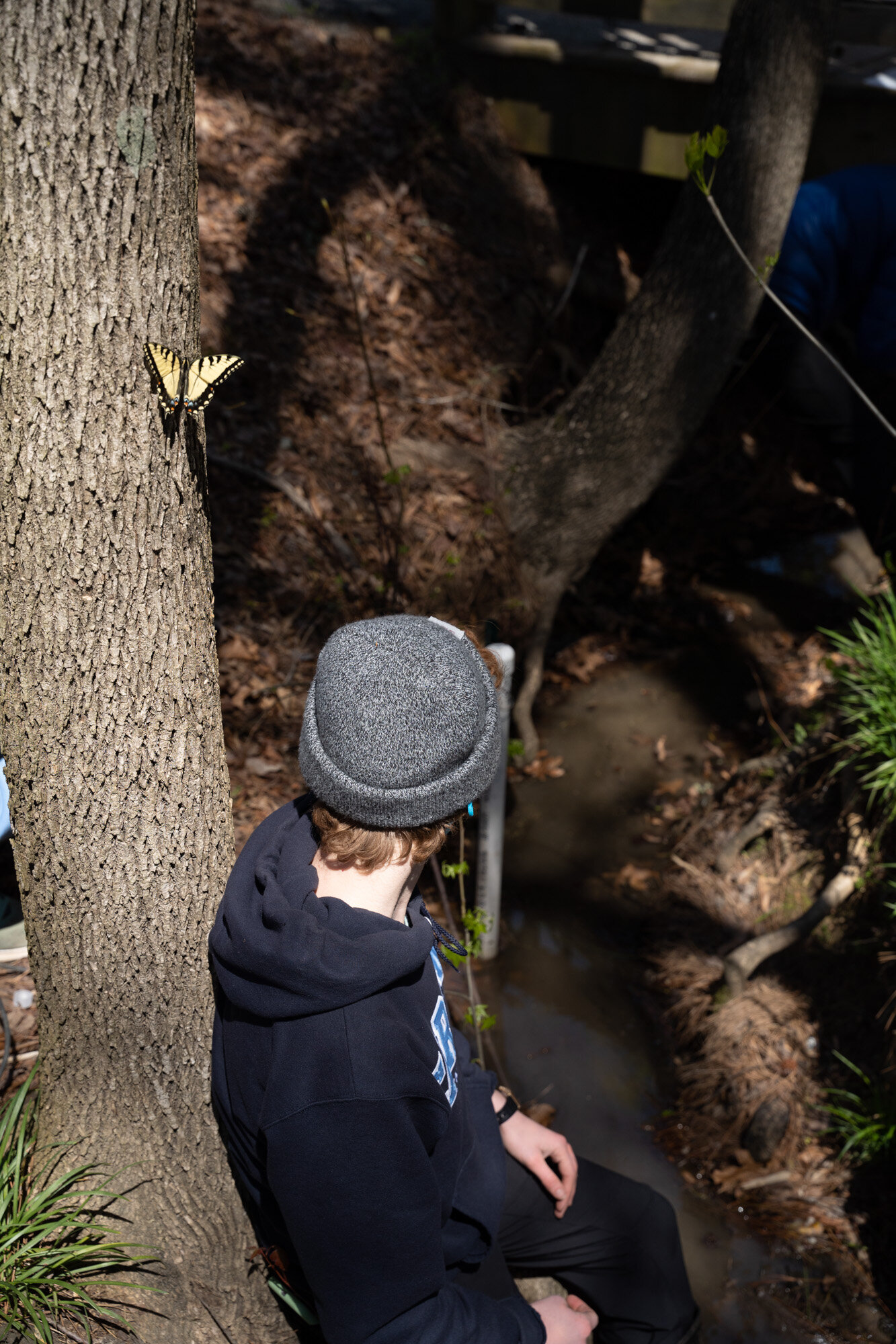  McMahon rests for a moment on the bank before helping Farquhar take notes of water velocity near the output of a bioretention pond in Durham, NC. 