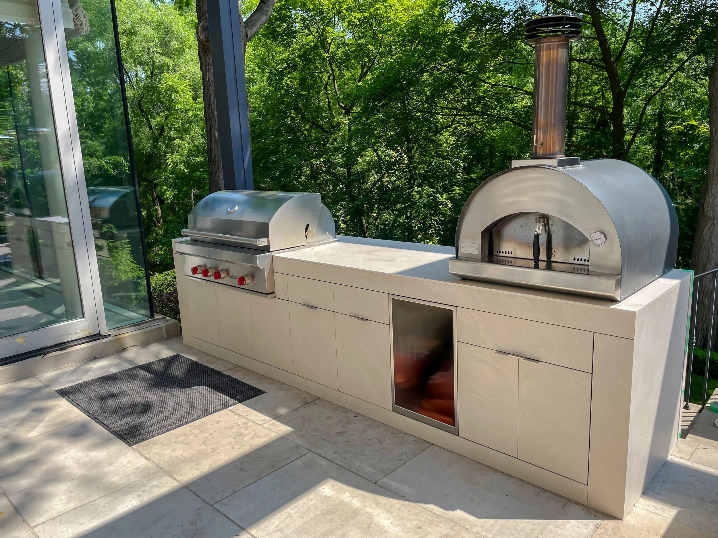 stone-clad-outdoor-kitchen-fontana-pizza-wolf-grill.jpg