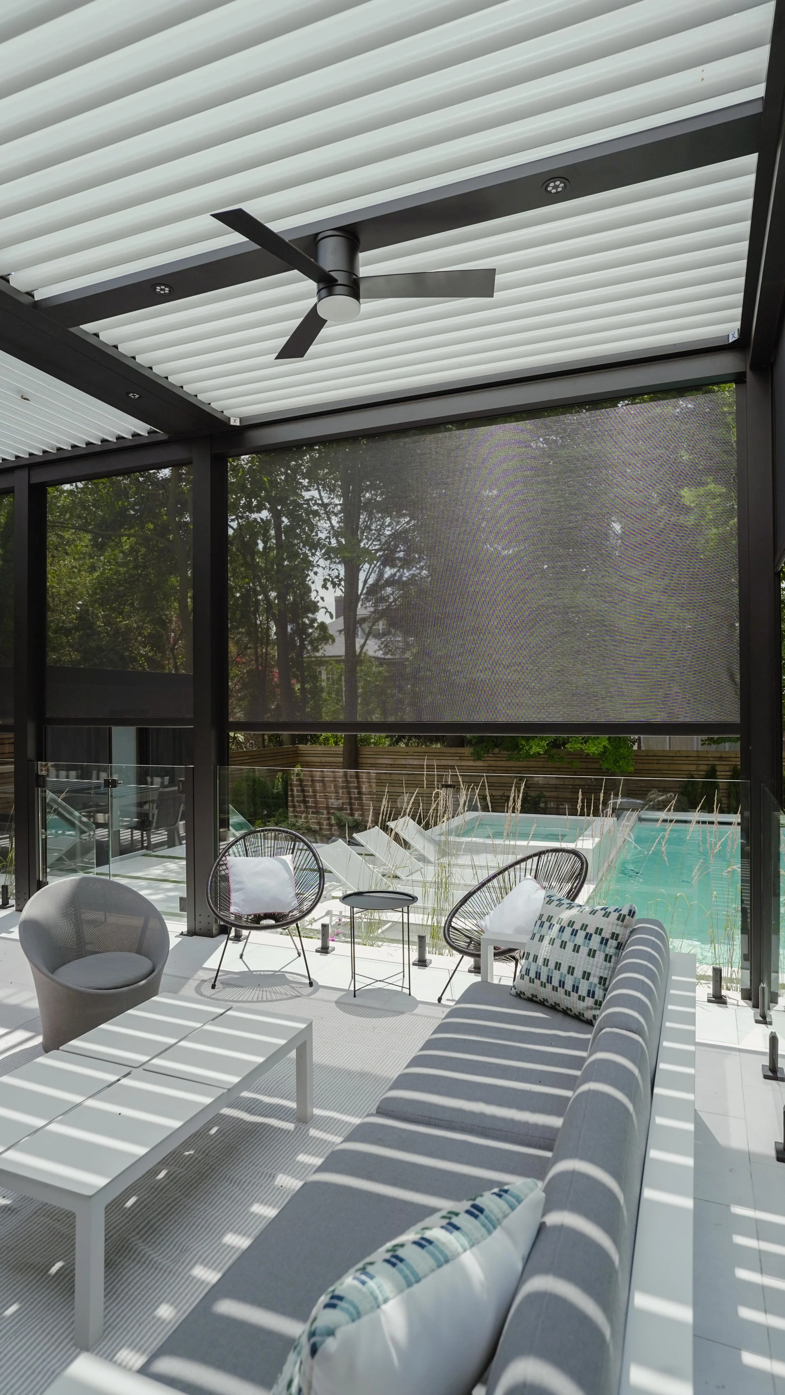 aluminum-pergola-motorized-screens-poolside-lounge-area.jpg