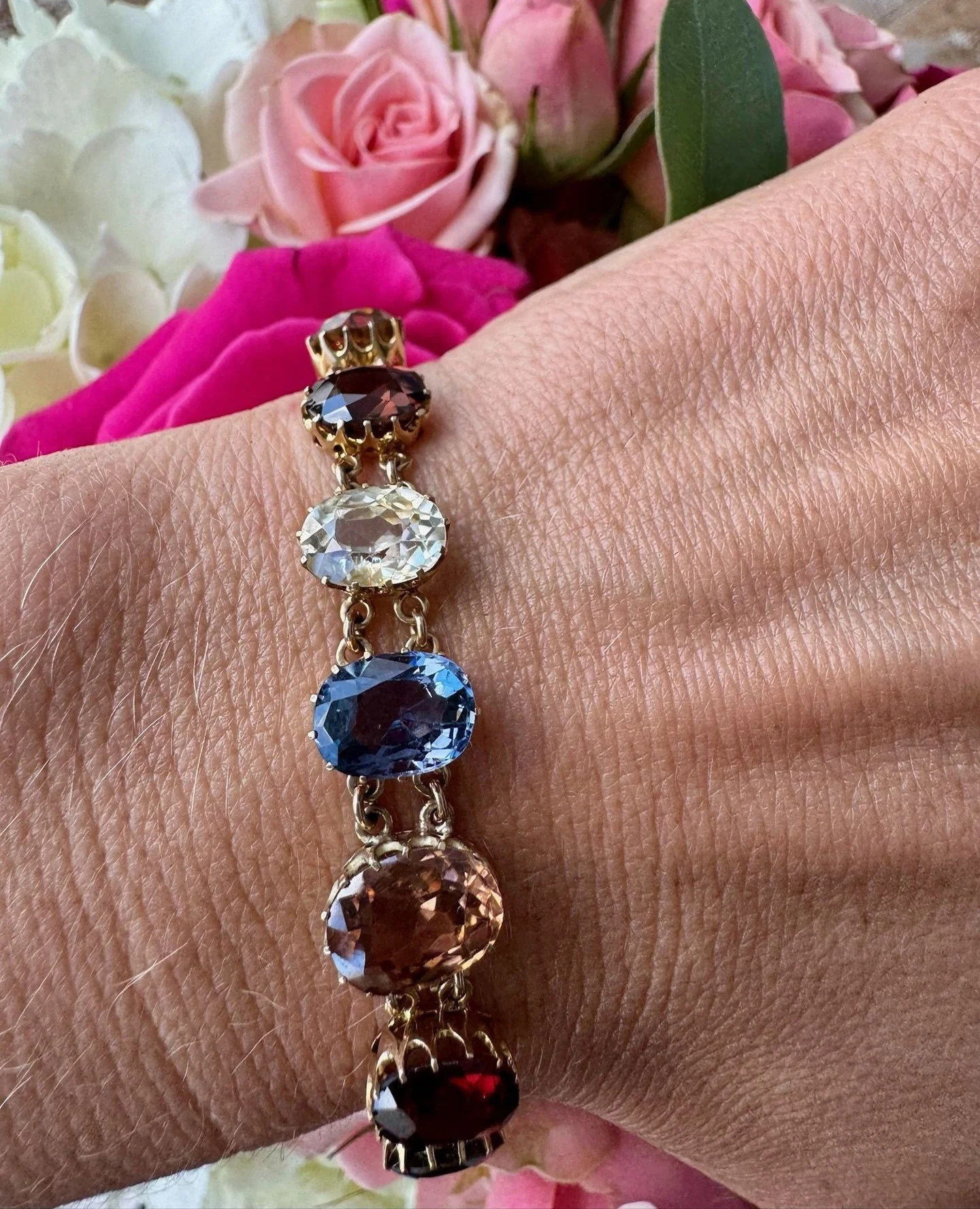 A true one of a kind, just like her.⁠
⁠
This Victorian Harlequin bracelet is a celebration of individuality, with 11 graduating oval cut gemstones, including natural sapphire, garnet, zircon, and spinel. Each stone carries its own color, character, a
