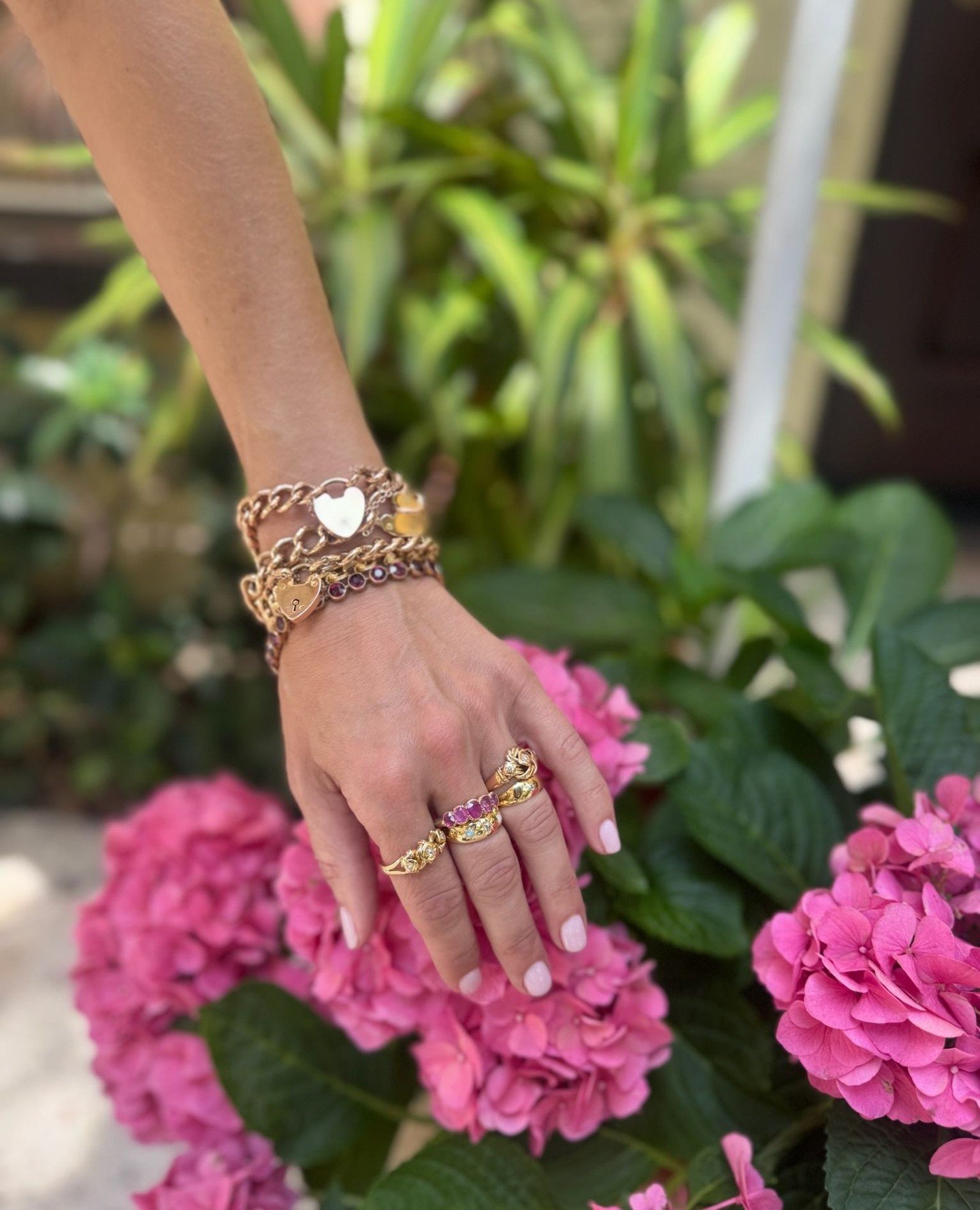 A pop of pink! Elegantly simple. 5 graduating richly hued pink cushion cut sapphires spread across the top of this exquisite half hoop ring