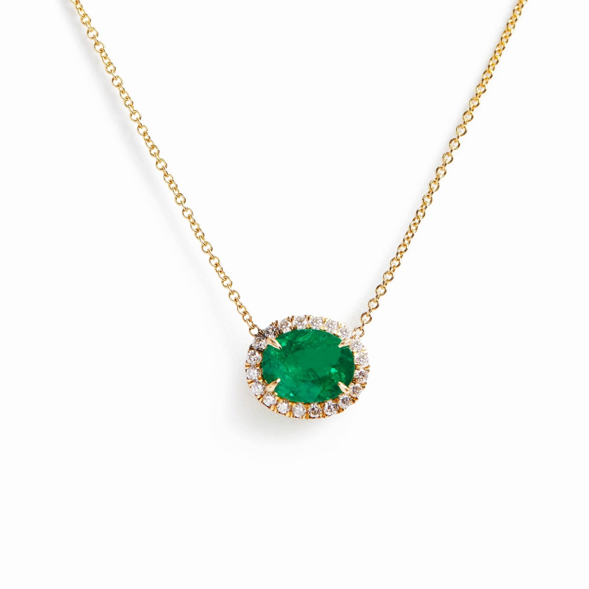 turner-tatler-custom-emerald-and-diamond-halo-necklace-1.jpg