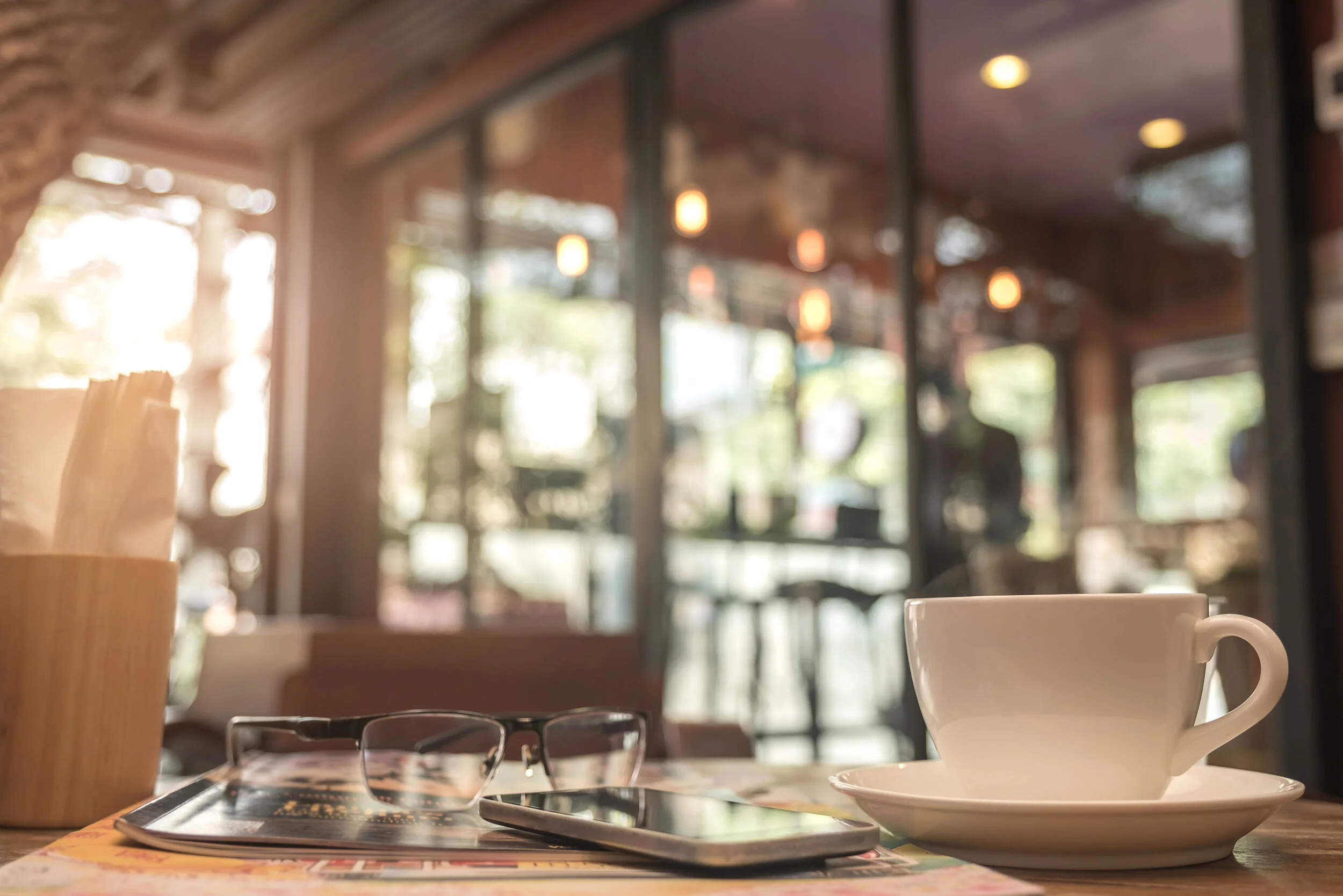 coffee-mug-with-cafe-blurred-background-PFDL8NW.jpg