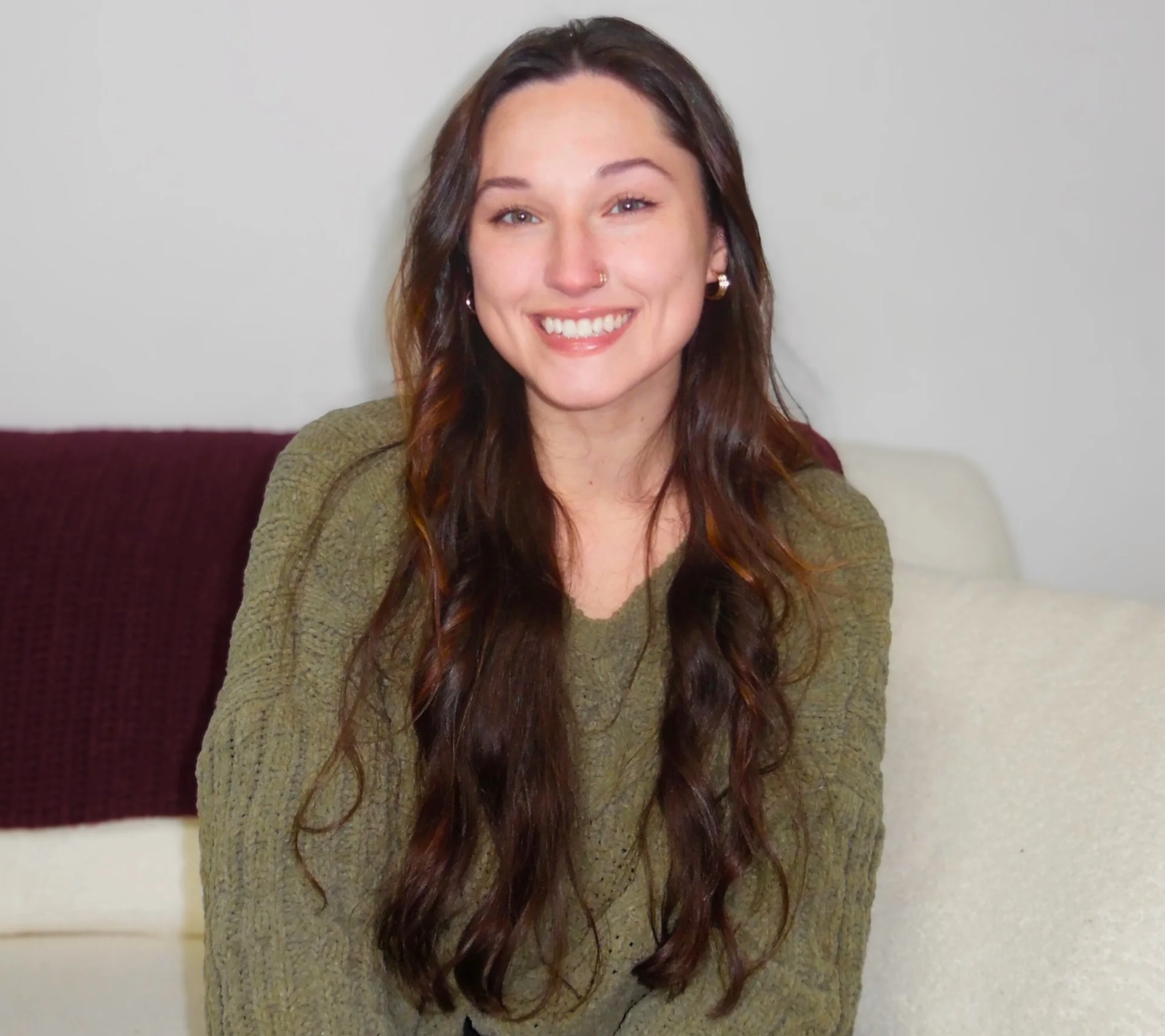 An image of Haley who is a white female with brunette hair, in a green blouse