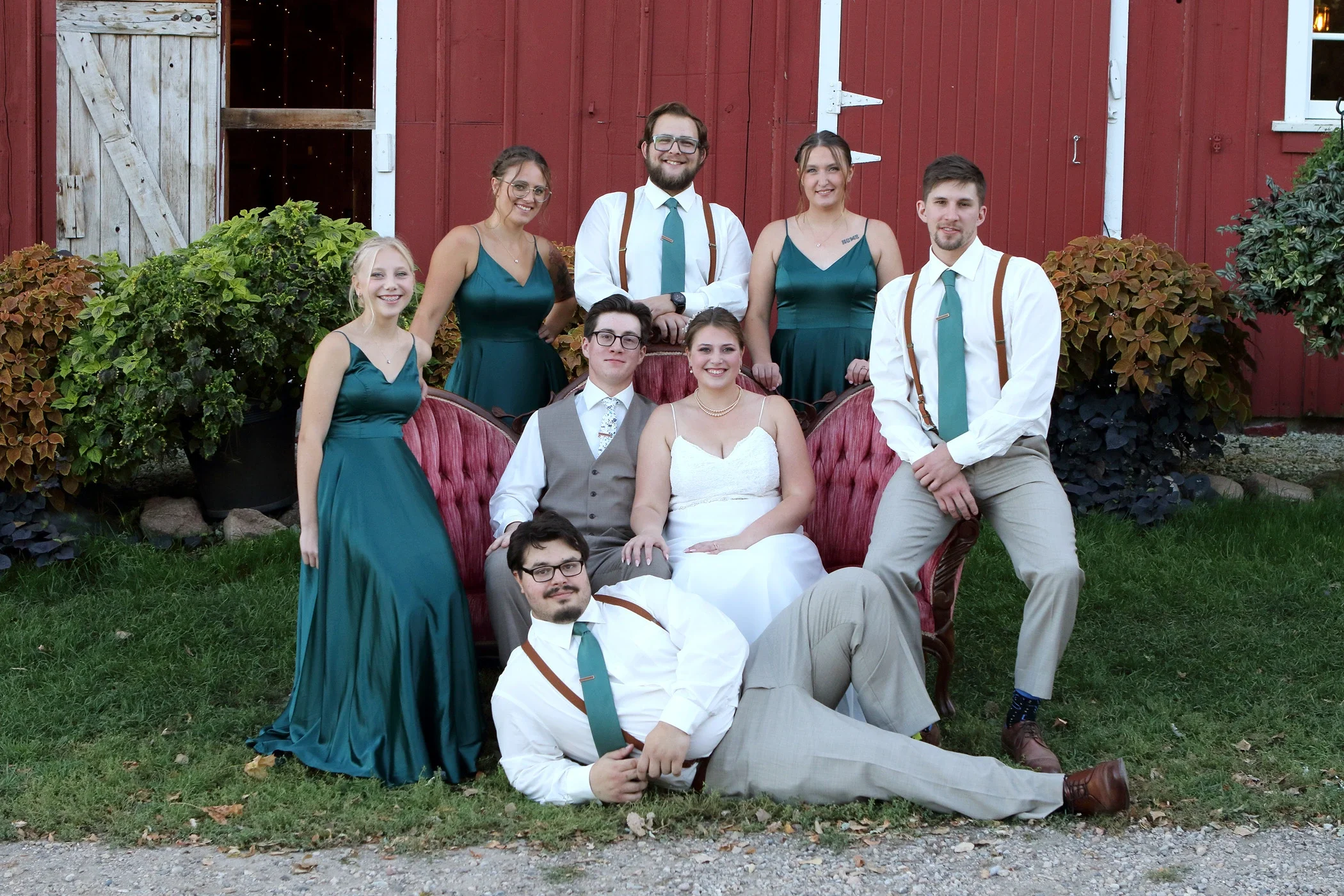 Wedding party poses outside of barn venue in MN