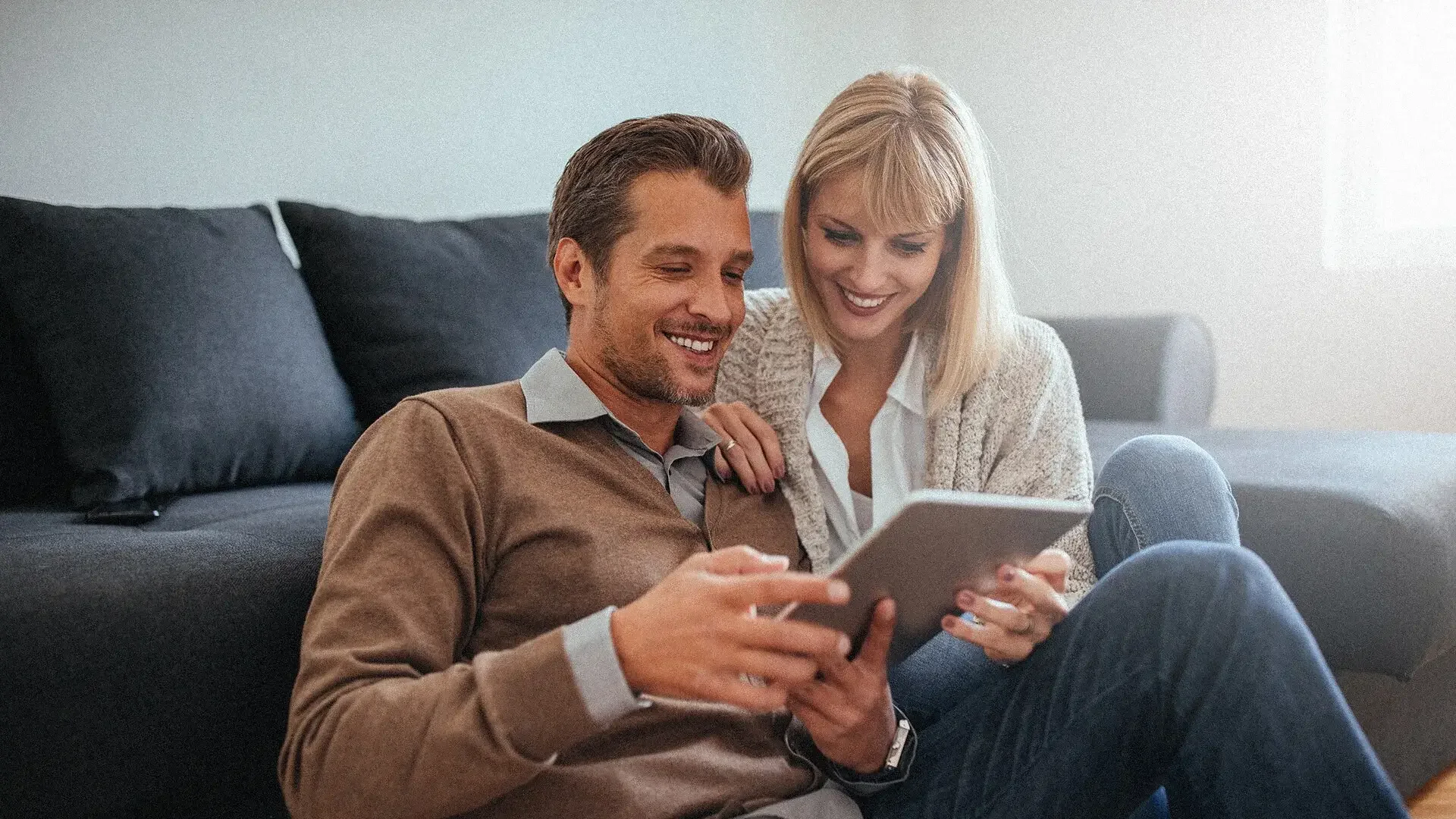 A happy couple searching for the best loan