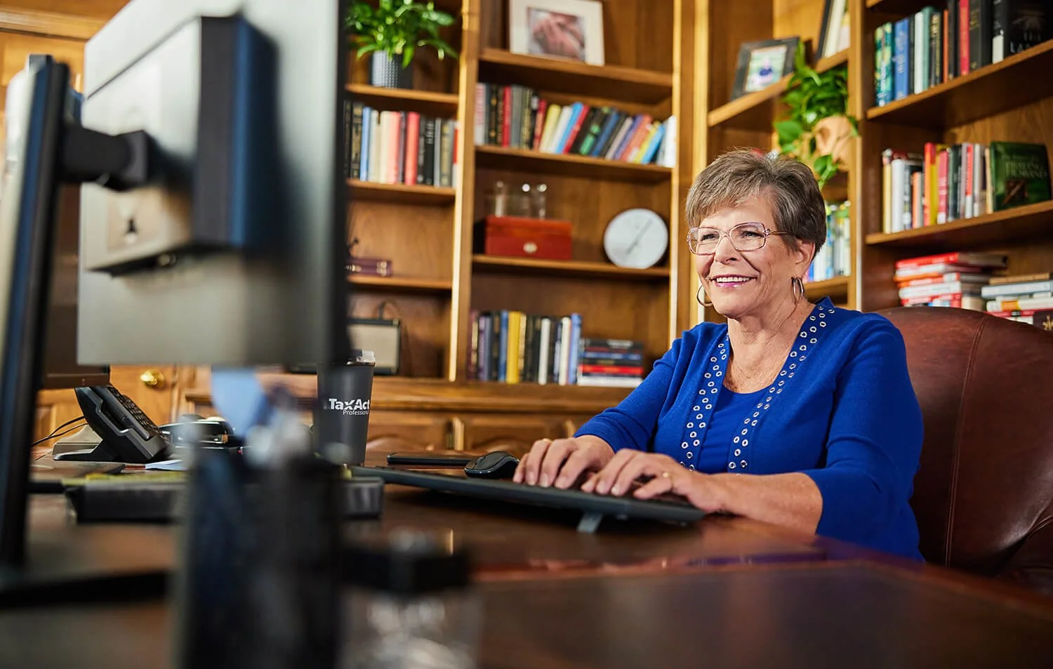 Professional corporate photography in Dallas capturing dedicated employees at work for TaxAct.