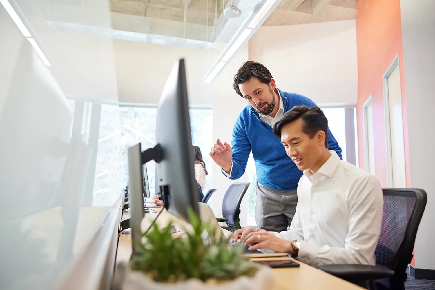 Dallas corporate photography capturing productive office discussions.