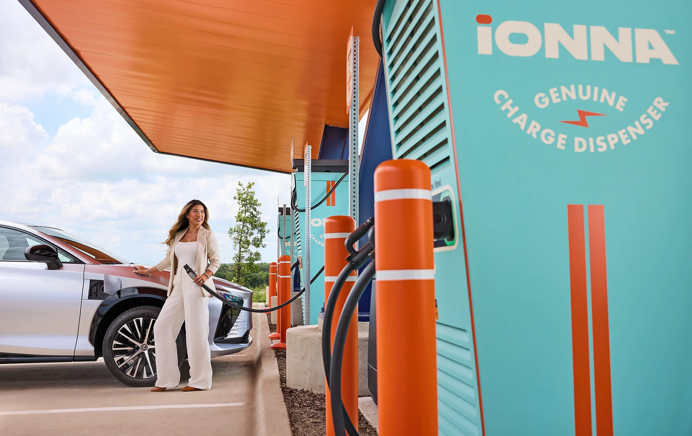 A woman about to plug in her Toyota electric vehicle at an iONNA charging station. 