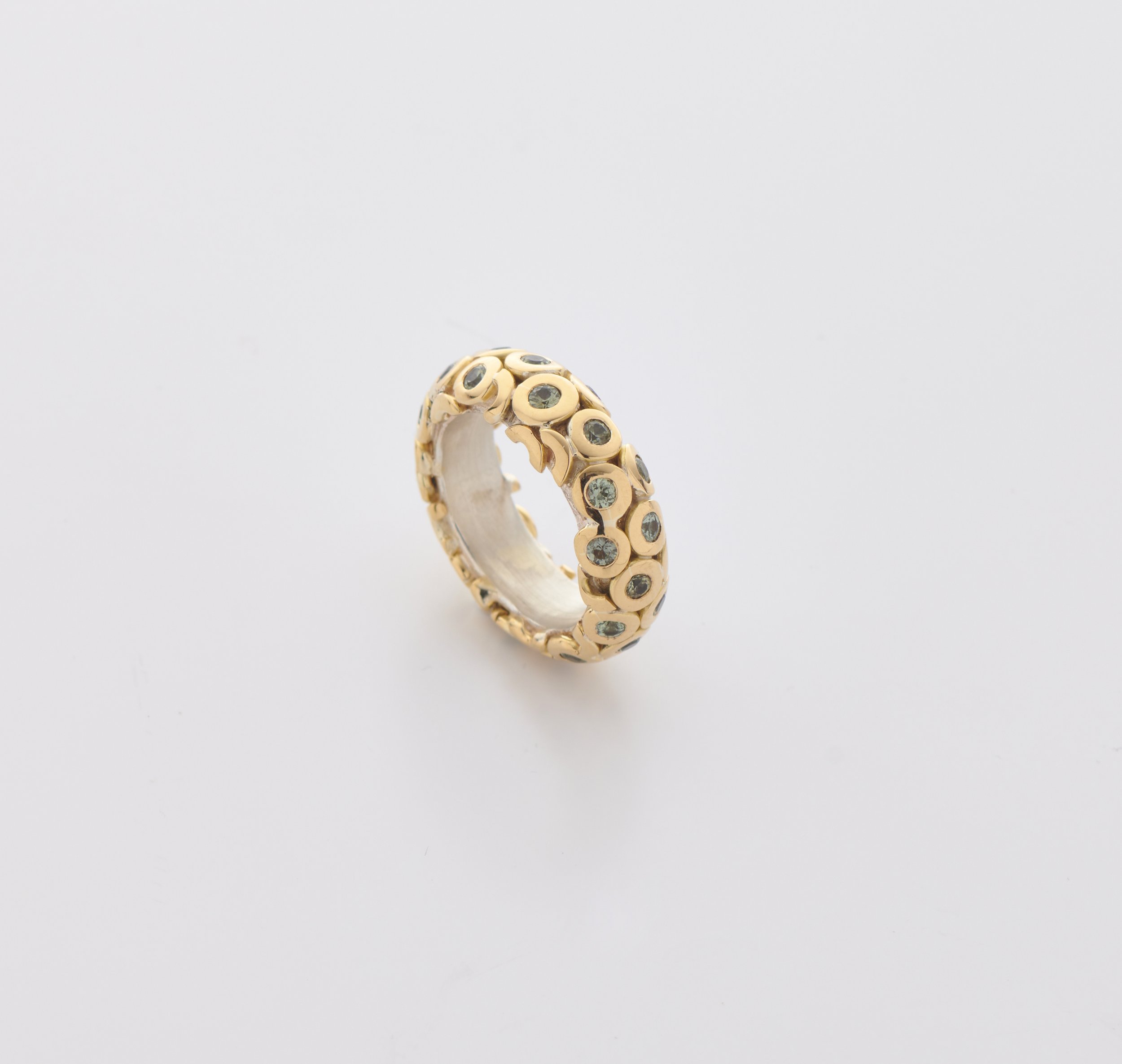 wide squid ring with green sapphires