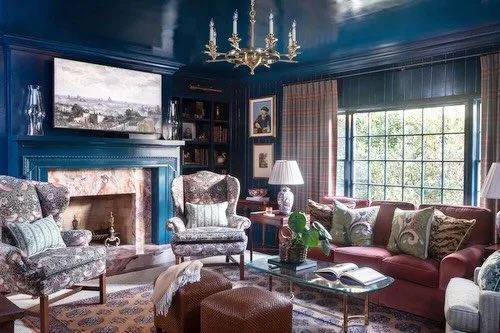 This color-drenched sitting room was designed around our client&rsquo;s love of antiques, thoughtfully incorporating their collected pieces alongside tailored upholstery, rich textures, and a mix of classic and contemporary art. The result is a cozy,