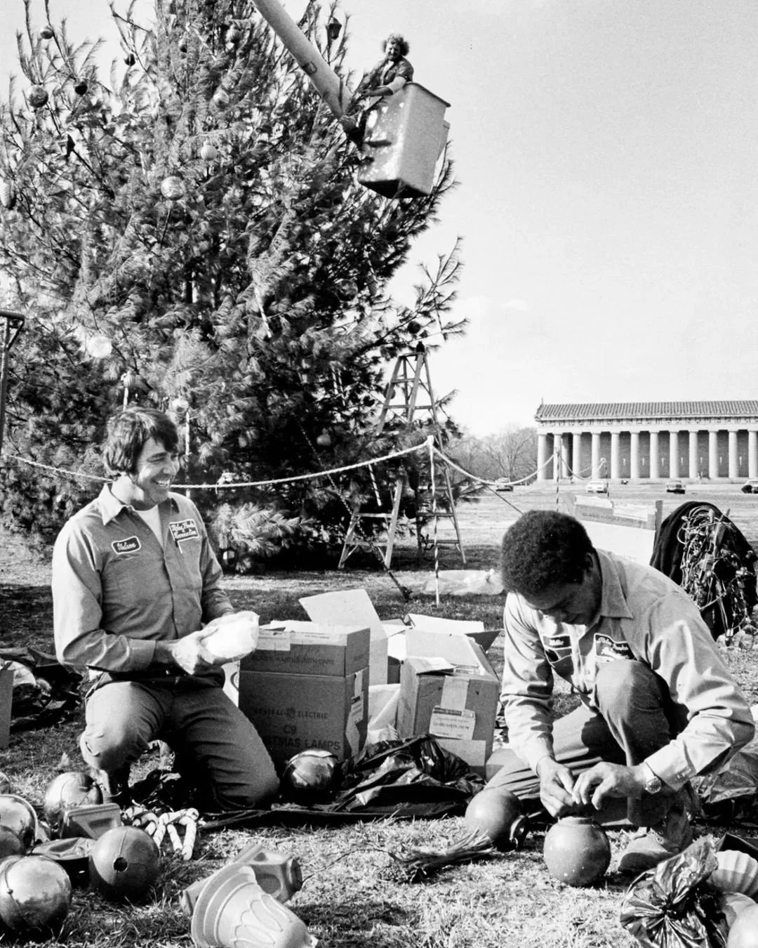 "Erecting a Christmas tree in Centennial Park Nov. 29, 1982, and preparing the decorations for it are George Watson, left, Willie Westmoreland, and way up there in the bucket, Tommy Raines."

Robert Johnson / @Tennessean 

#centennialpark #