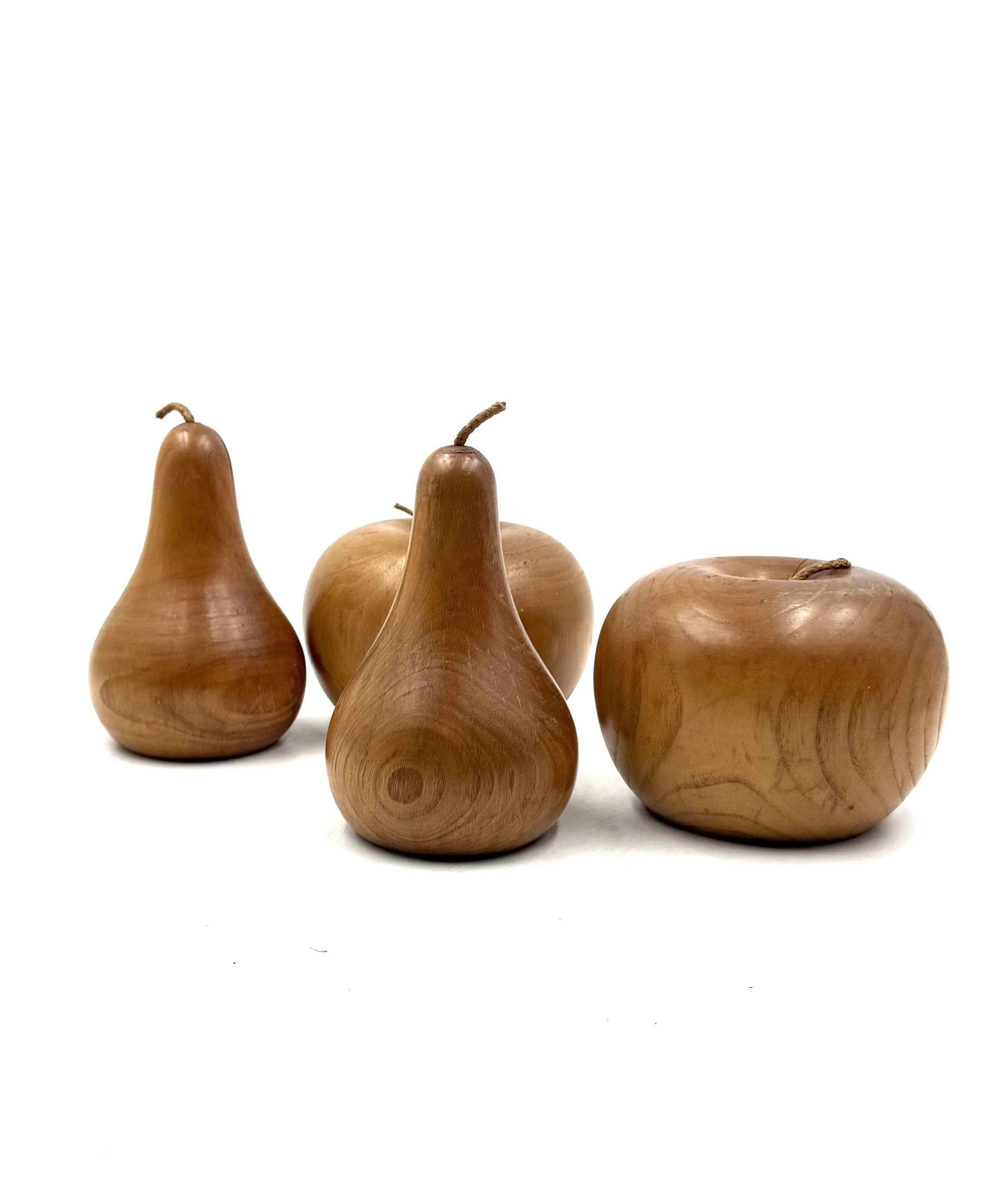 A set of hand-carved decorative fruit made from warm-toned pear wood, varying in height from 11cm to 17cm, Italy 1960s