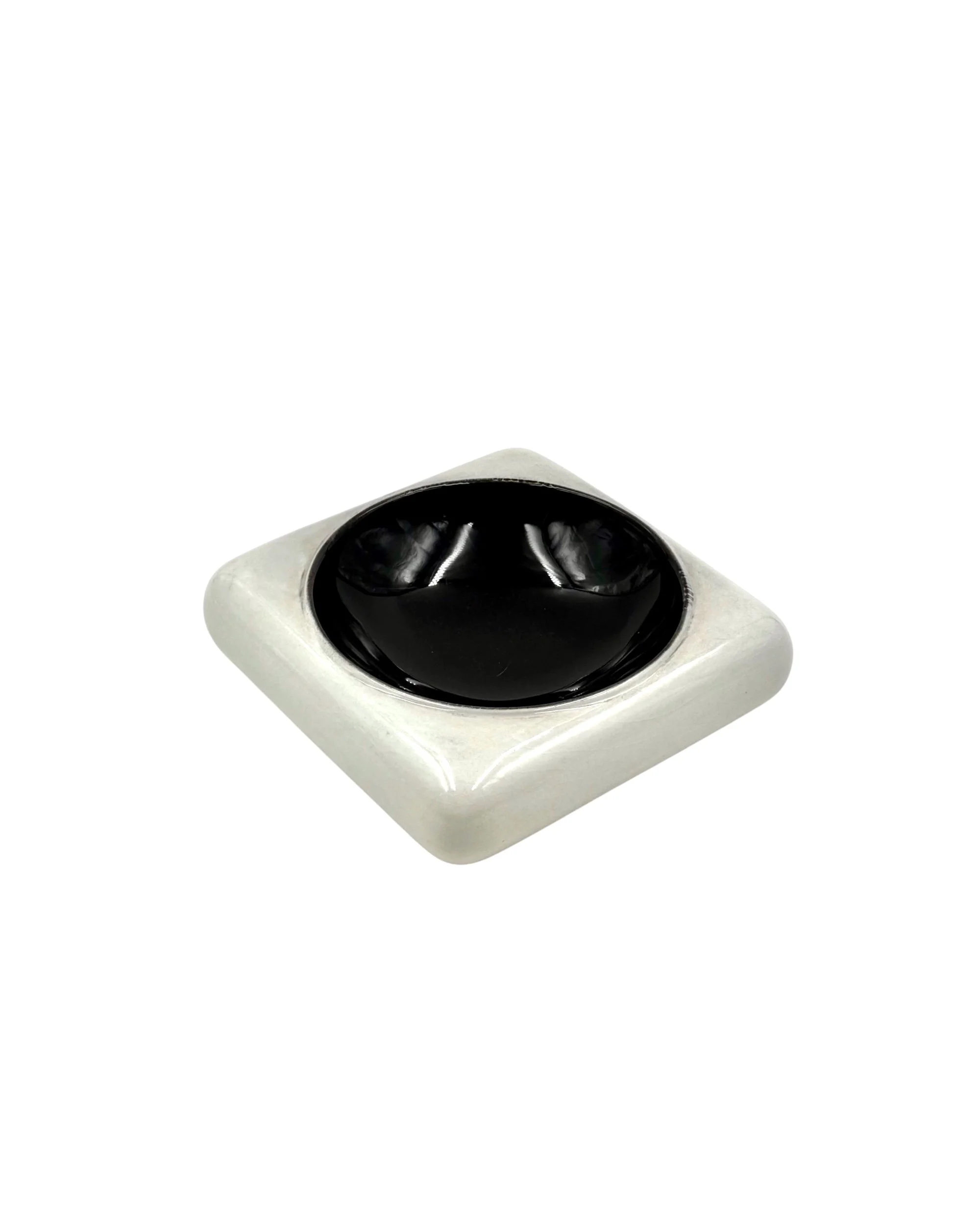 Vintage Italian Space Age ceramic ashtray in black and white, 1970s modernist vide poche with geometric design, top view.