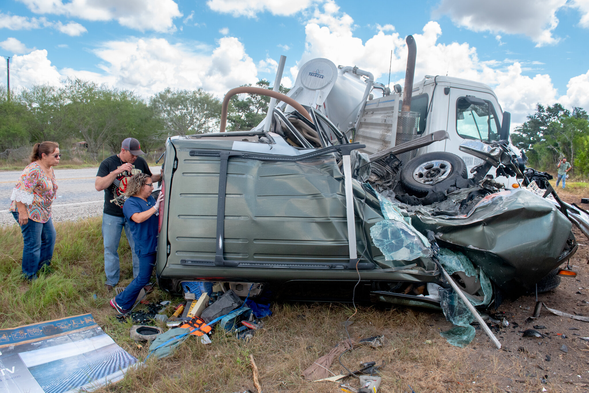 A passing nurse attempts to reach the victim of a collision outside Meyersville, TX. Years after this Victoria County crash, authorities arrested the driver of the tractor-trailer on a criminally negligent homicide charge. Texas Department of Publi