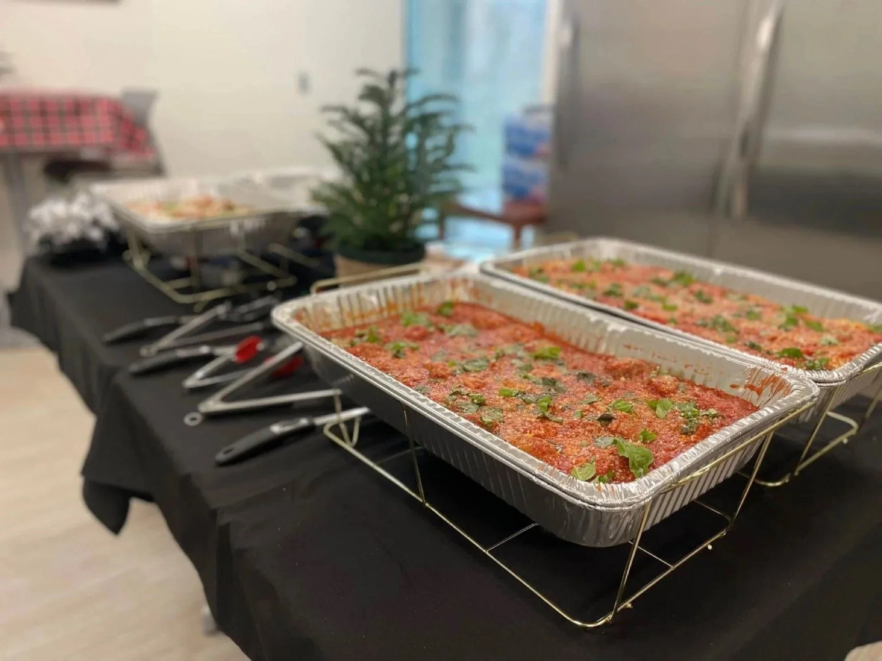 Hot Italian catering trays ready to serve for an office lunch