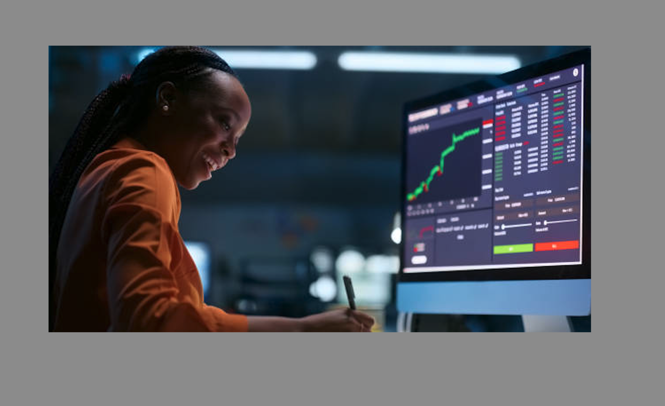 Trader studying a stock chart on a large monitor