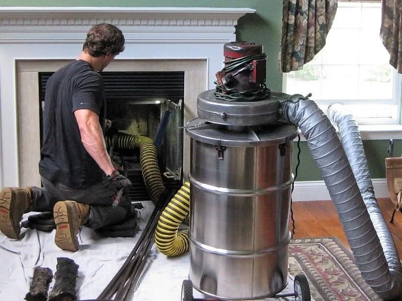 Bryan sweeping a fireplace chimneyh