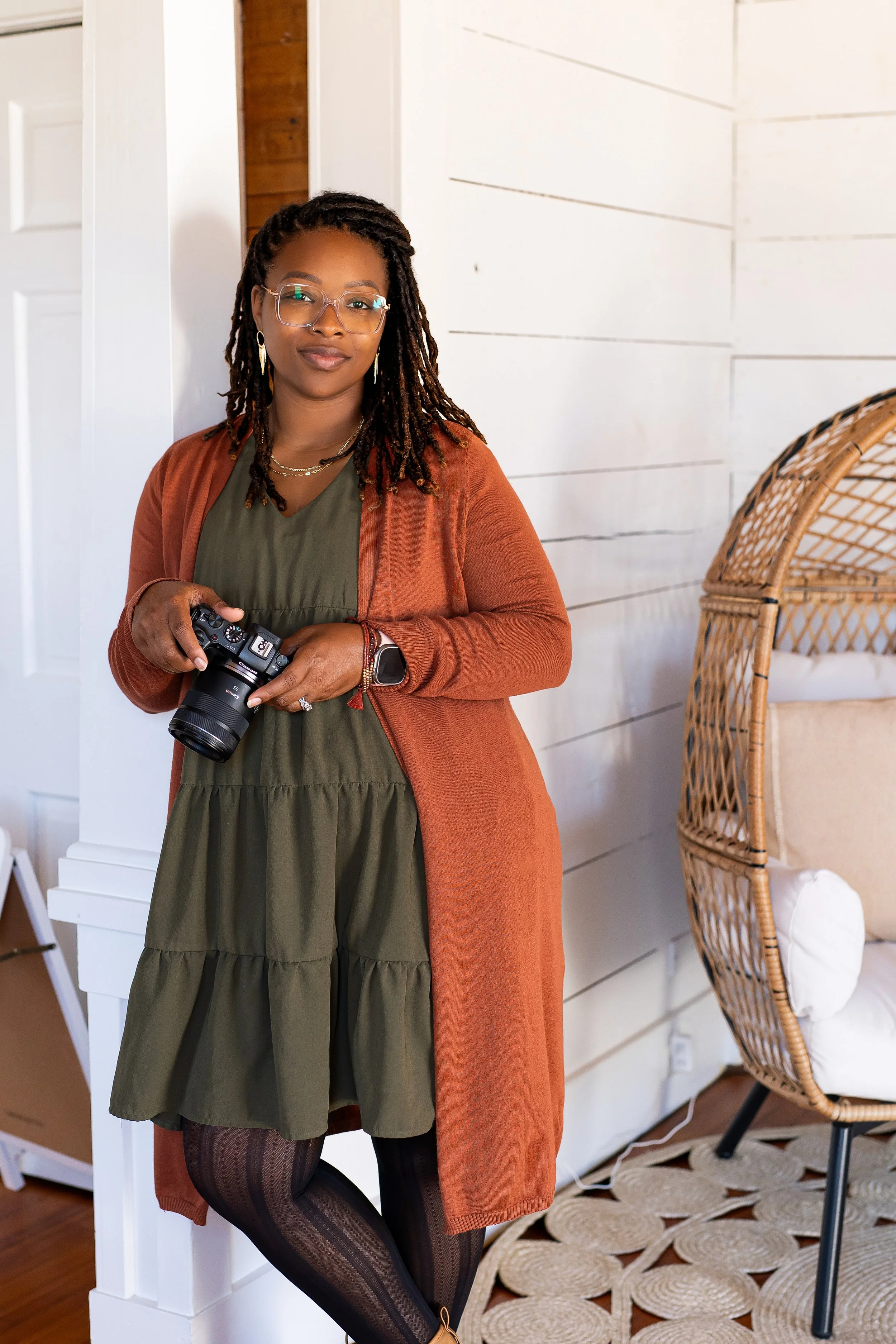 Jackie Larkin holding her camera during an indoor branding portrait for her South Mississippi photography business.