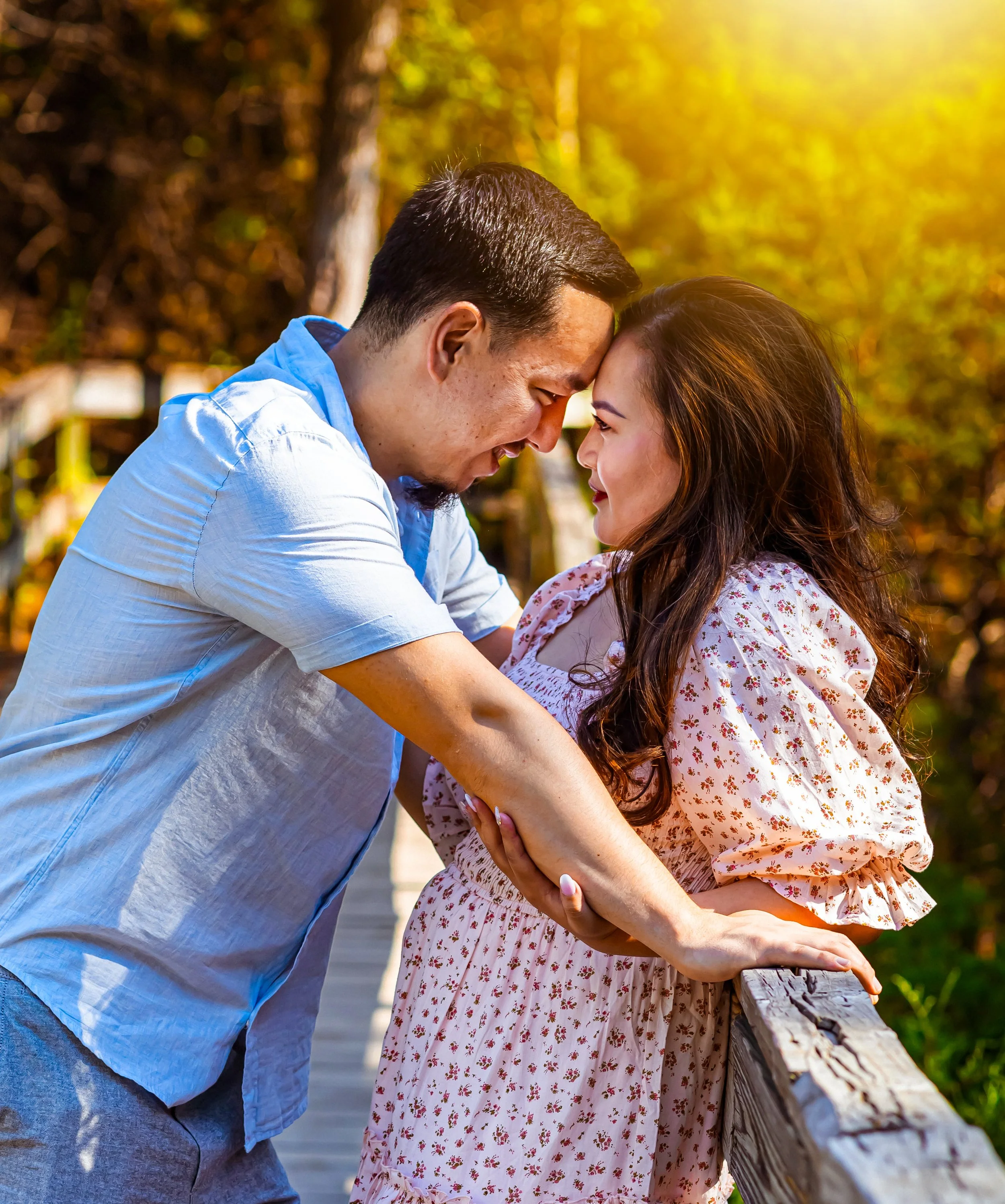 Couple sharing a tender moment during an outdoor anniversary session in south Mississippi.