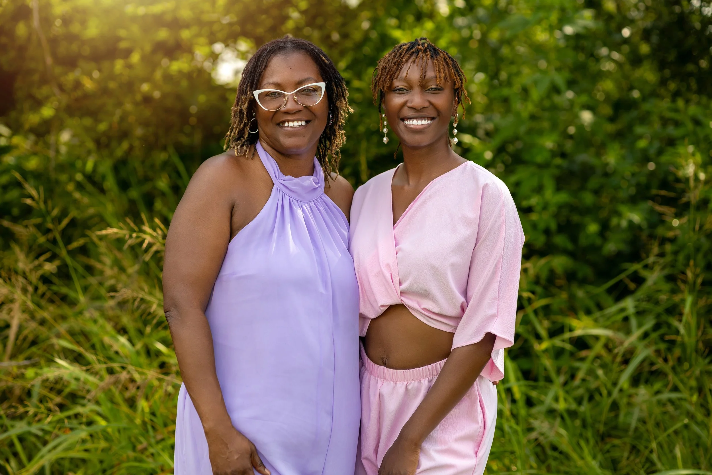Mother and daughter smiling together during an outdoor family portrait session in South Mississippi
