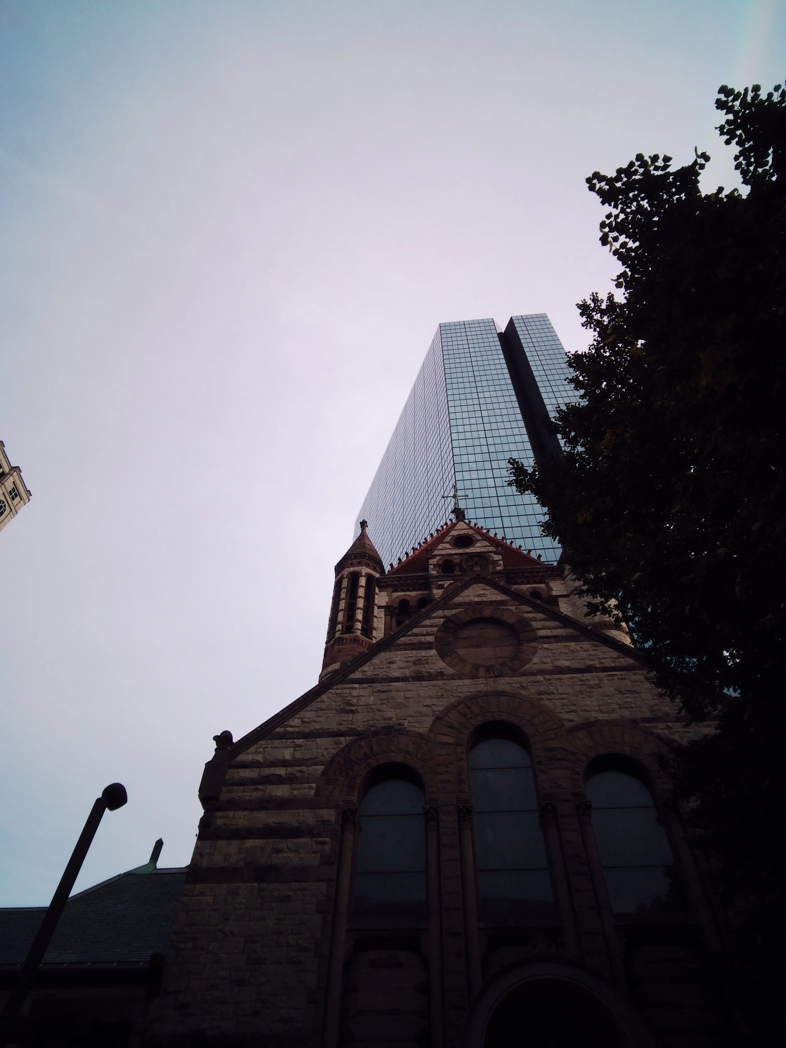 "wow, jarring to see old next to the new"
"isn't it a thing that they built churches with tall steeples to be closer to God?"
"oh right... but wait... that building is taller in the background. Does that mean capitalism is closer to God??" 
"...uhoh"