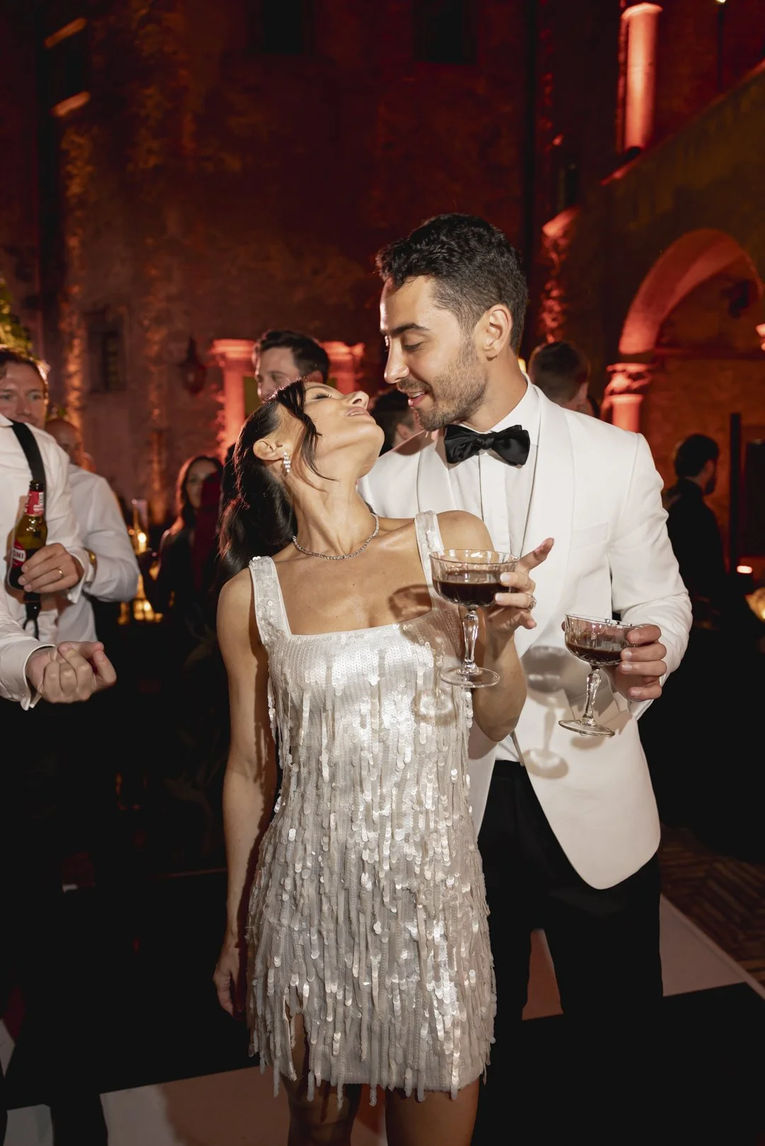 Chandeliers and candles lighting up a castle wedding dinner in Italy