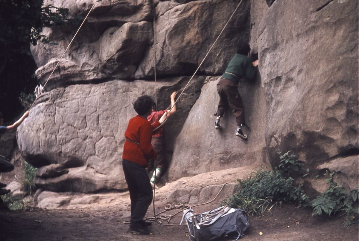 Alison Higham top roping at Harrisons Rocks with a college climbing club circa 1967. Note: no harnesses or belay devices!