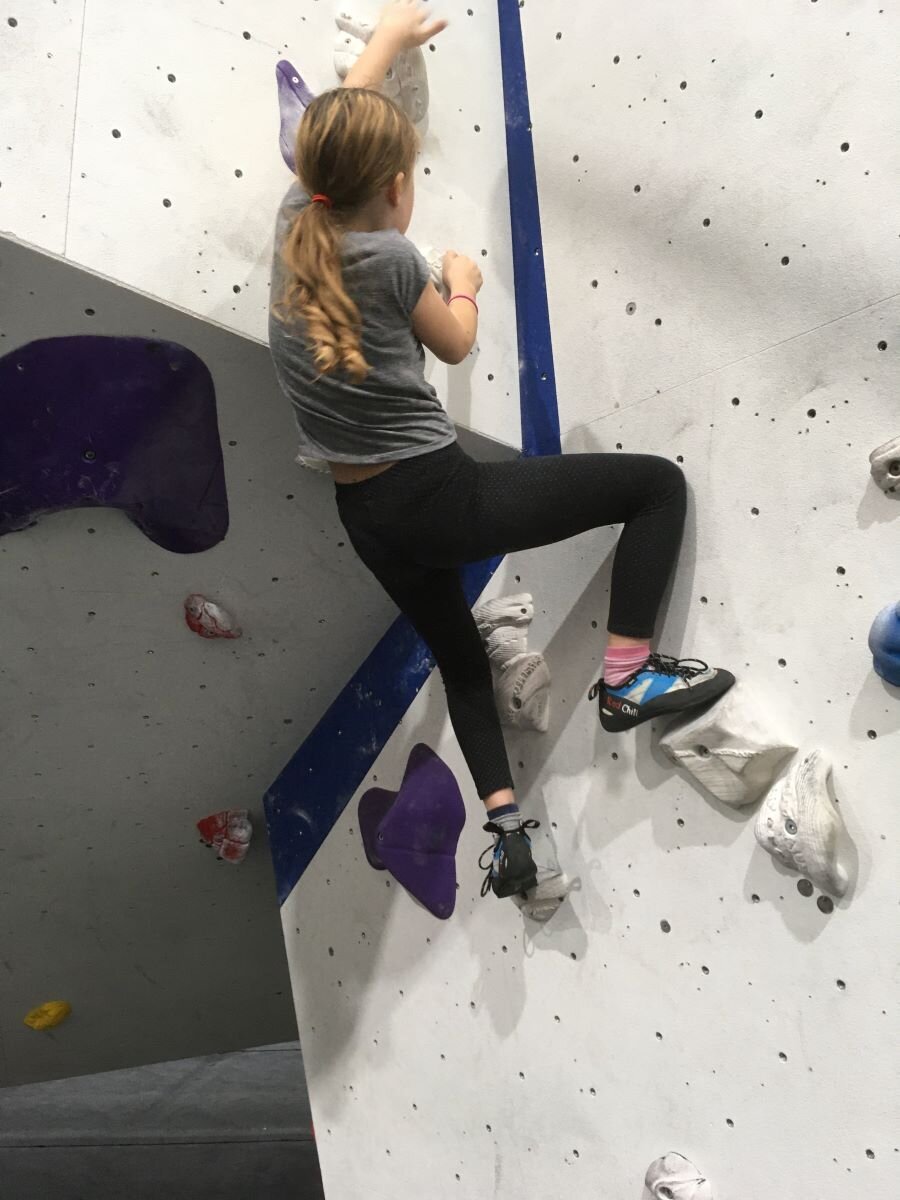 Cleo, age 9, bouldering, with Grandma advising and spotting