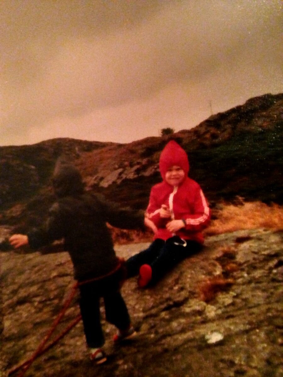 Jenny Gaiawyn age 3 (in black), playing at climbing with her sister 'belaying'. Jenny is now in her 40s and wears a harness and rock boots and insists her belayer actually holds the rope