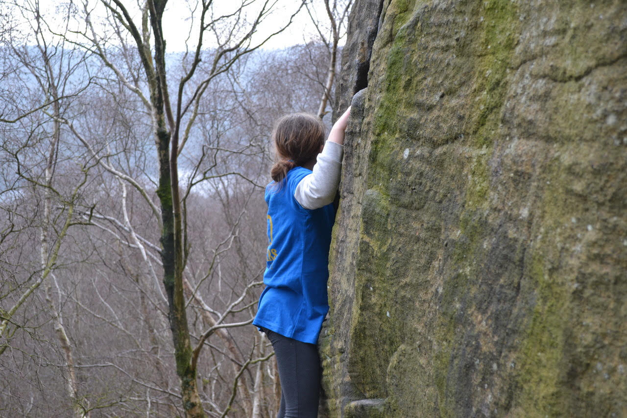 Cleo, age 9, playing around on boulders at a local crag