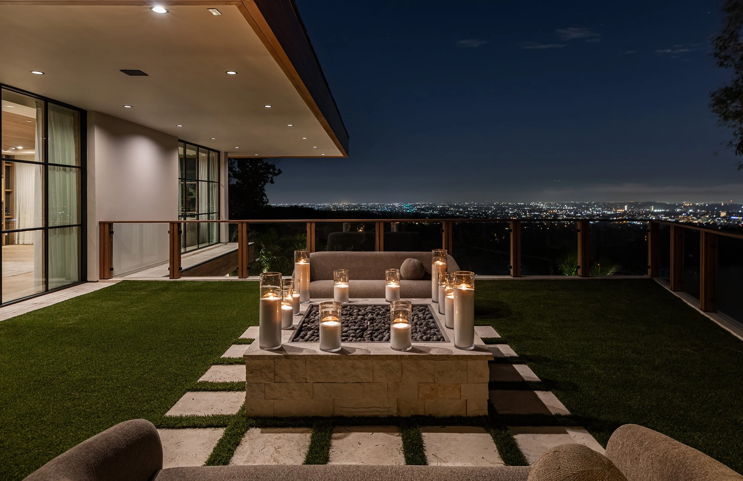 Franklin Canyon Beverly Hills luxury home modern terrace at night with fire feature & views