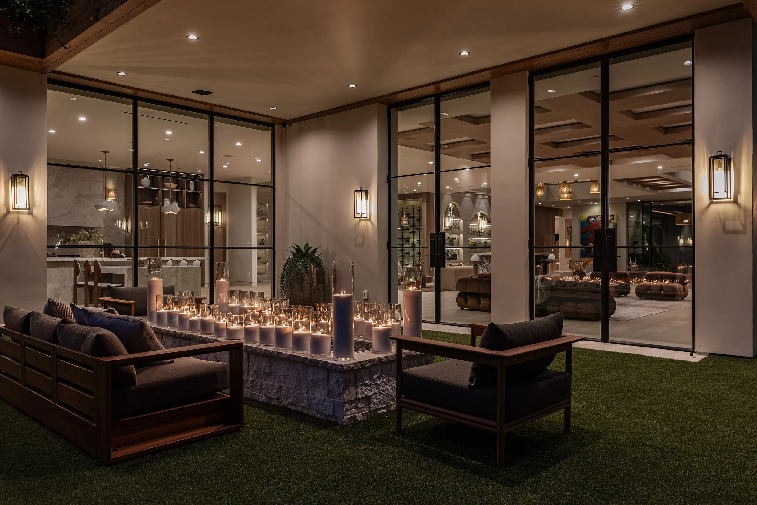 Franklin Canyon Beverly Hills luxury home at night with modern outdoor lounge & fire pit