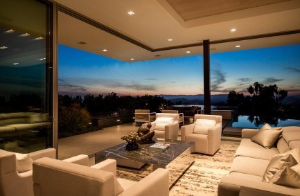 Modern luxury Beverly Hills home glass wall living room that opens to the pool terrace