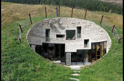 Hobbit house bunker style underground home in Switzerland, a modern earth shelter built into the hillside with a green grass roof