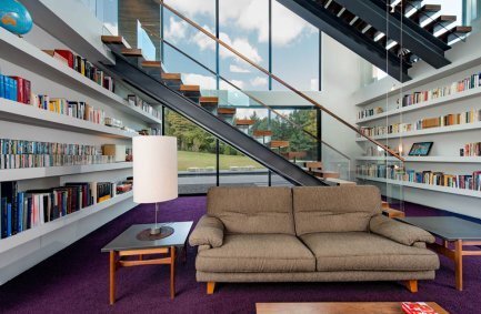 Bright interior in the library reading room beneath floating stairs at our modern Walker Road house in Great Falls, Virginia