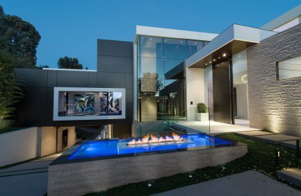 Glass wall modern luxury mansion front entrance with fire features at our Laurel Way house in Beverly Hills 