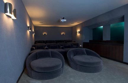 Luxury home movie theater with windows that look underwater into the pool at our Hopen Place house in the Hollywood Hills 