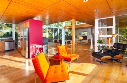 Our Rustic Canyon bright, modern, light filled home remodel featuring a glass and wooden interior with pops of bright color seen here in the open plan living room
