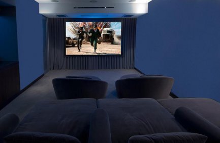 Hollywood Hills luxury home movie theater with plush seating and lighting