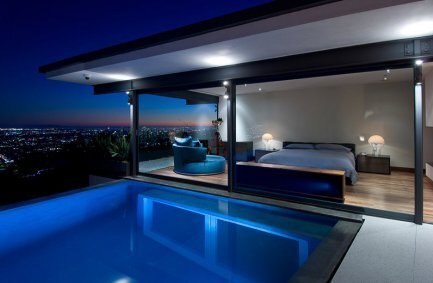 Hopen Place Hollywood Hills modern home poolside bedroom design with sleek floor to ceiling glass walls and city views