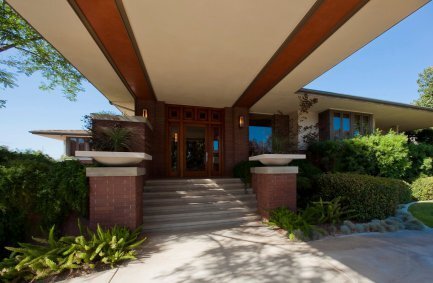 Covered driveway parking and stairs to front entrance at our modern Prairie style house in California