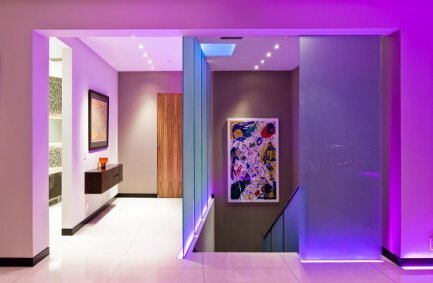 Colorful LED lights and modern art in the sleek interior design of our Harold Way house in the Hollywood Hills