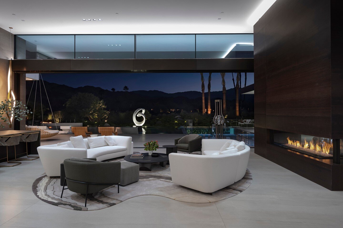 The luxury indoor outdoor living room at our Serenity House, with sliding glass walls and mountain views. Photo by @maccollum