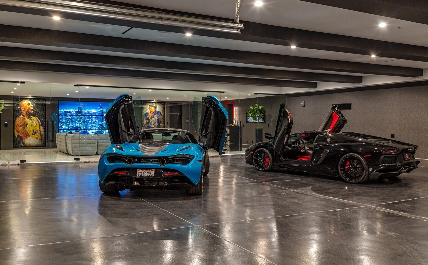 The luxury car garage at our Bundy Drive House doubles as a display room, sitting just behind the floor to ceiling glass walls of the entertainment lounge. Photo by @berlynmedia