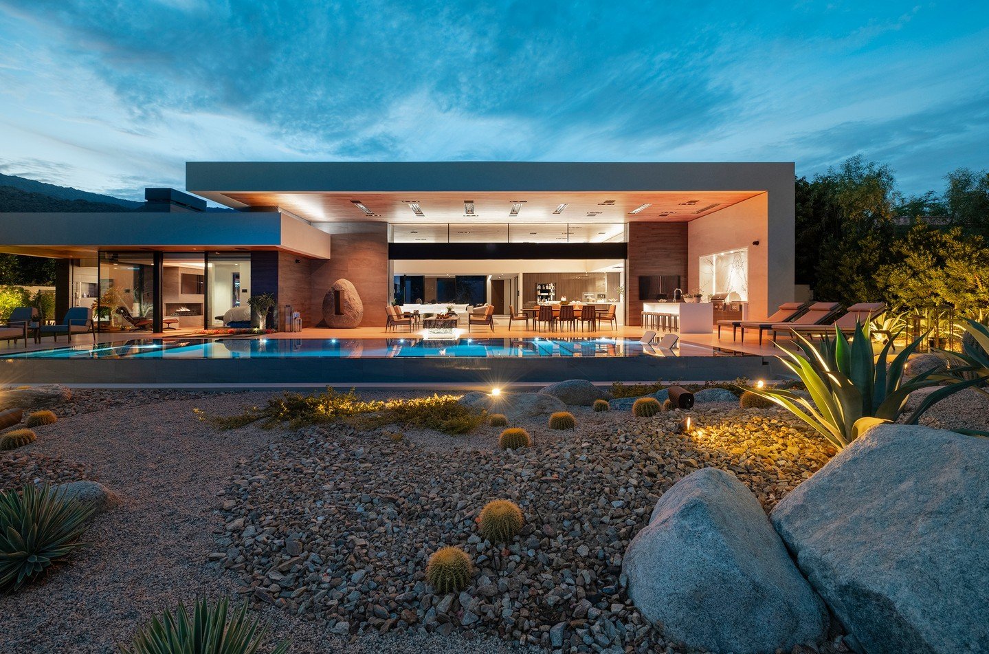 The modernist design of our Bighorn House opens up interior spaces to a backyard swimming pool, cactus garden, and views. Landscape architecture by @attingerlandscapearchitecture, pool by @azurepoolsandspas, and photo by @maccollum