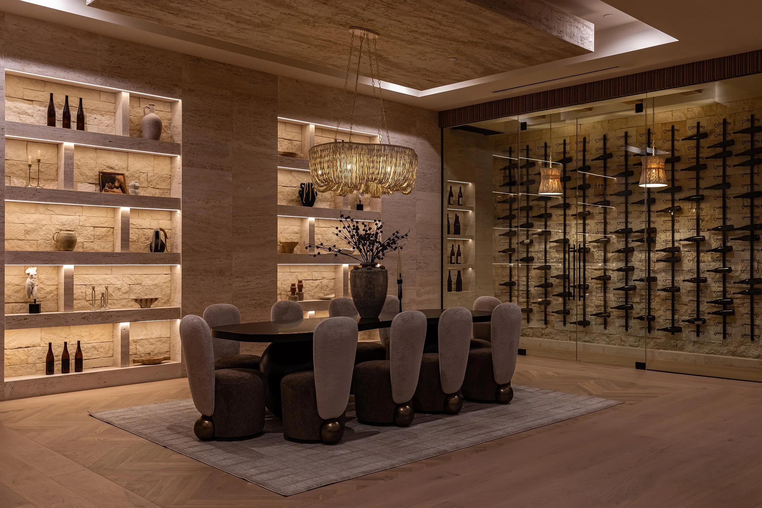 Franklin Canyon Beverly Hills modern home luxury dining room with glass enclosed wine cellar lit at night